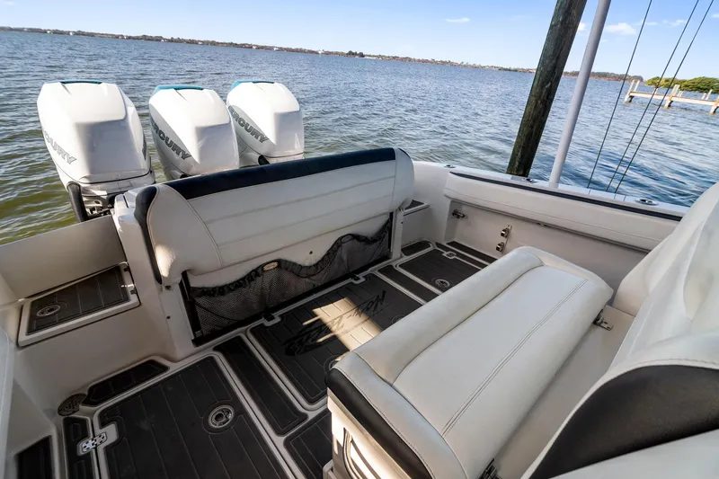 Slide: The Image of 2018 Nor-Tech 340 Sport Center Console boat interior with triple Mercury engines. - 23