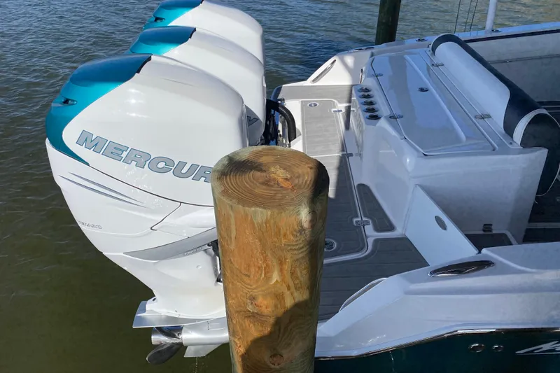 Slide: The Image of 2018 Nor-Tech 340 Sport Center Console with triple Mercury outboard engines docked. - 24
