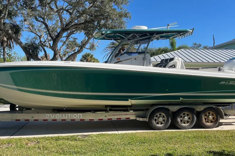 Slide: The Image of 2018 Nor-Tech 340 Sport Center Console boat on trailer, parked outdoors. - 28