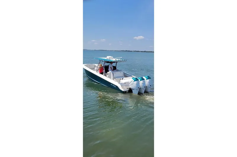 Slide: The Image of 2018 Nor-Tech 340 Sport Center Console boat cruising on calm water. - 29