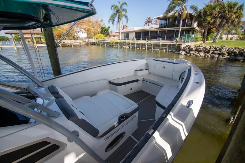 Slide: The Image of 2018 Nor-Tech 340 Sport Center Console boat docked by waterfront home. - 7