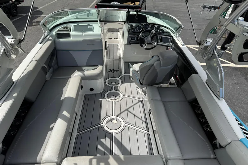 Slide: The Image of 2017 MasterCraft XT23 boat interior with sleek seating and modern dashboard design. - 5