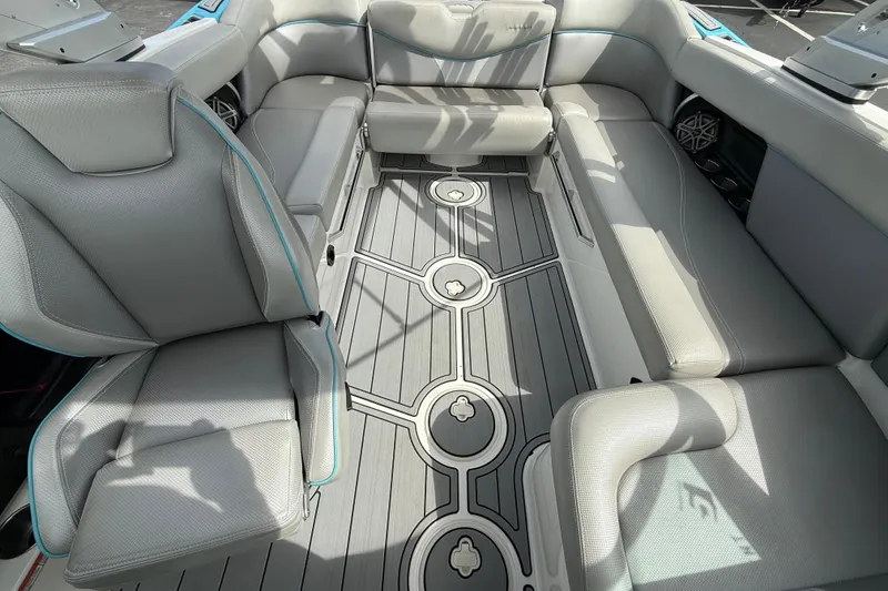 Slide: The Image of 2017 MasterCraft XT23 boat interior with gray seating and stylish flooring design. - 6