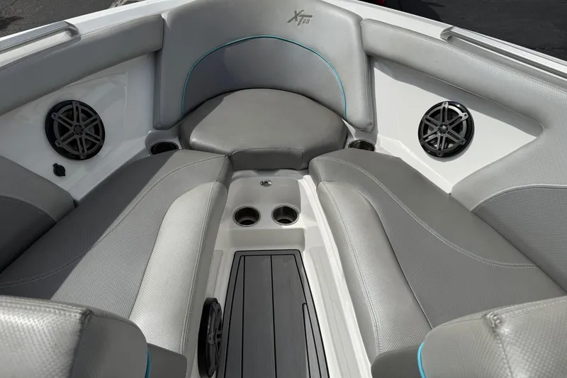 Slide: The Image of 2017 MasterCraft XT23 boat interior with gray seating and built-in speakers. - 8