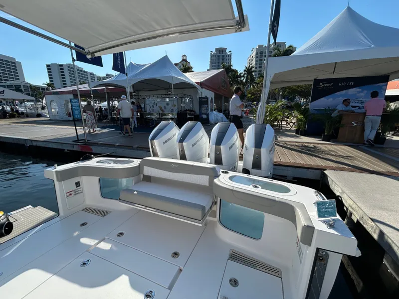 Slide: The Image of Scout 435 LXF 2026 at a boat show dock. - 5