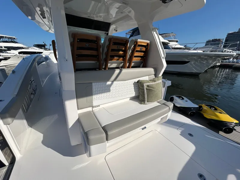 Slide: The Image of Scout 435 LXF 2026 yacht with luxurious seating area at the marina. - 6