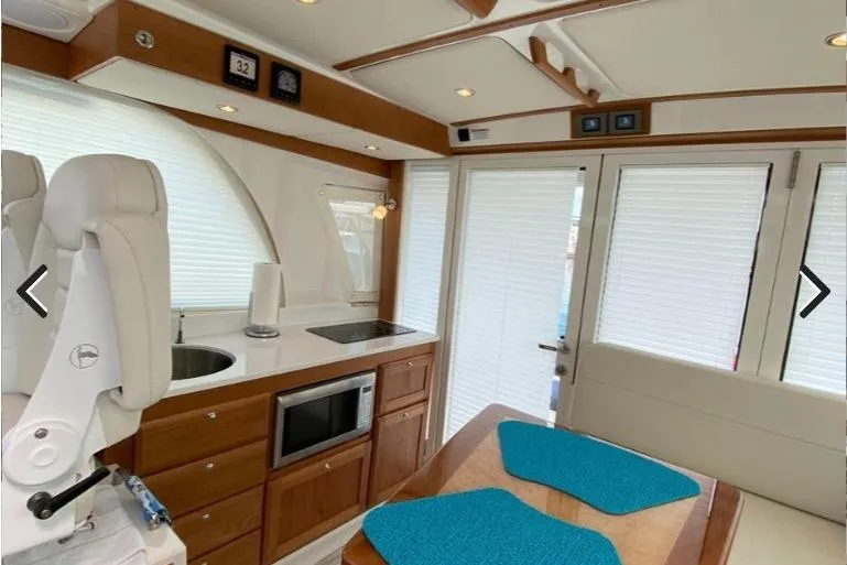 Slide: The Image of Luxurious interior of 2022 Back Cove 39O yacht with modern kitchen and dining area. - 12