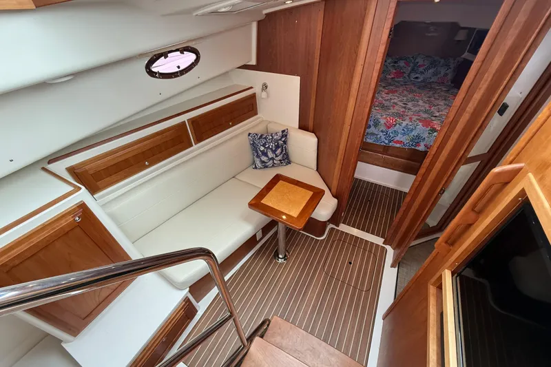 Slide: The Image of 2022 Back Cove 39O yacht interior with seating, table, and cabin view. - 48