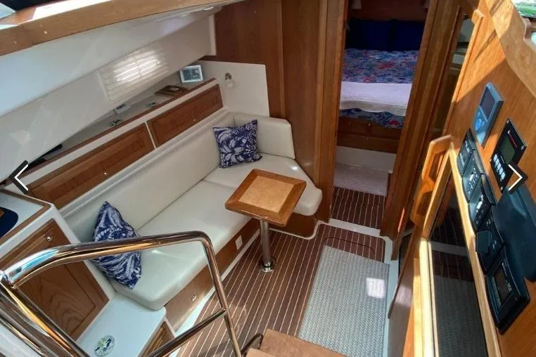 Slide: The Image of 2022 Back Cove 39O yacht interior with cozy seating, wooden accents, and modern amenities. - 13
