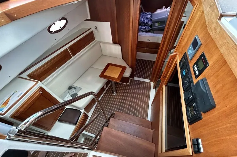 Slide: The Image of Interior of 2022 Back Cove 39O yacht, featuring wood finishes and cozy seating area. - 14