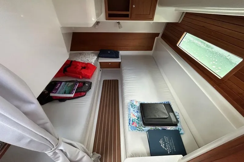 Slide: The Image of Interior cabin of 2022 Back Cove 39O boat with cozy seating and storage. - 16