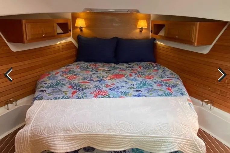 Slide: The Image of Luxurious cabin interior of 2022 Back Cove 39O with cozy bedding and warm lighting. - 17