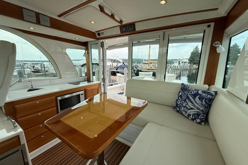 Slide: The Image of Luxurious interior of 2022 Back Cove 39O yacht with elegant seating and scenic marina view. - 32