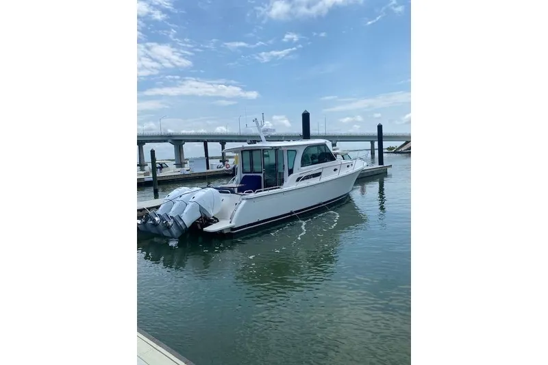 Slide: The Image of 2022 Back Cove 39O boat docked in marina under clear blue sky. - 3