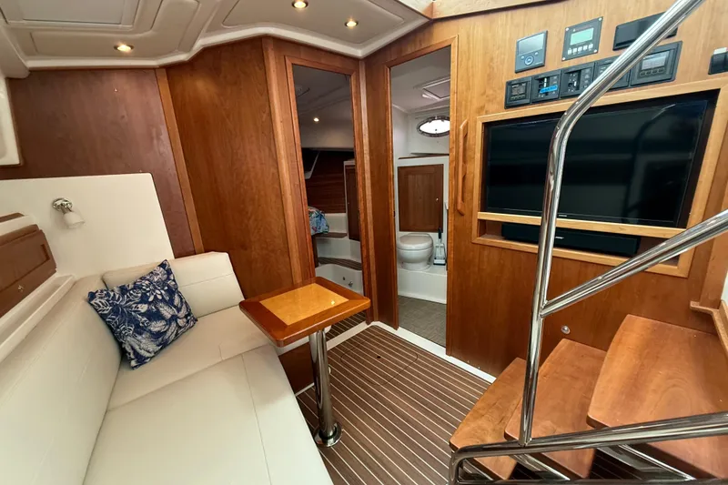 Slide: The Image of Interior of 2022 Back Cove 39O yacht with wood paneling, seating, and modern amenities. - 54