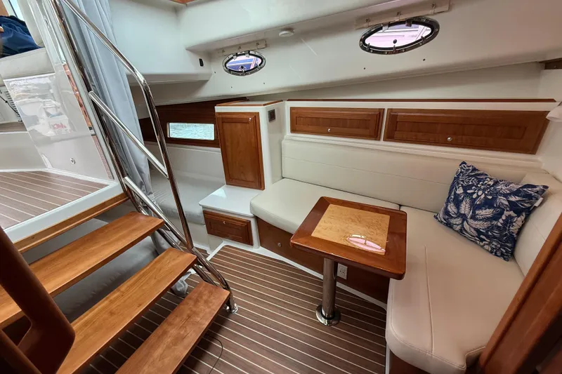 Slide: The Image of Interior of 2022 Back Cove 39O yacht with wooden accents and cozy seating area. - 50