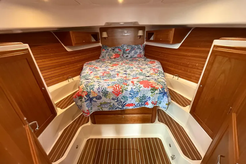 Slide: The Image of Luxurious cabin interior of 2022 Back Cove 39O with floral bedding and wooden accents. - 57