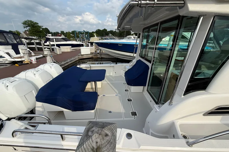 Slide: The Image of 2022 Back Cove 39O boat docked, featuring spacious seating and modern design. - 19