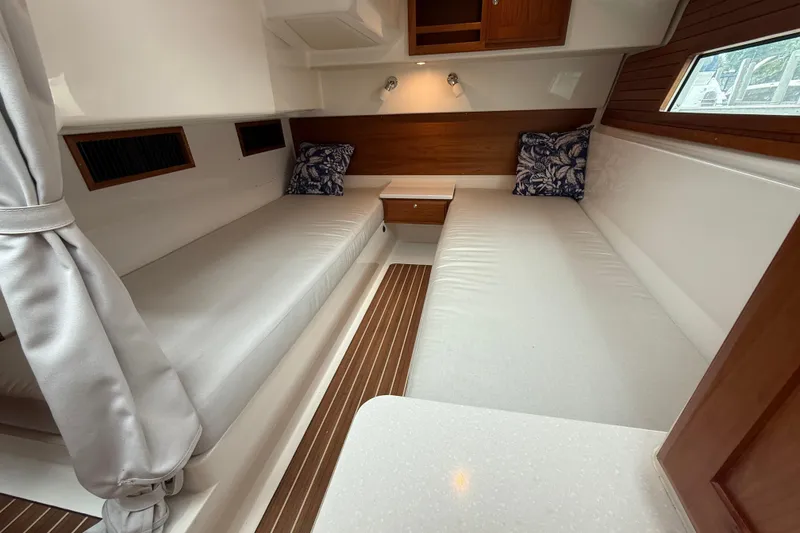 Slide: The Image of Interior cabin of 2022 Back Cove 39O boat with twin beds and wooden accents. - 61