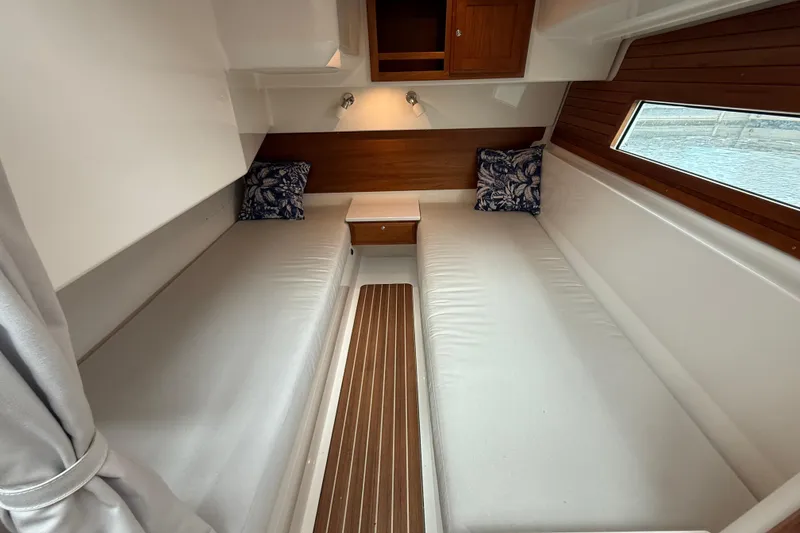 Slide: The Image of Interior cabin of 2022 Back Cove 39O boat with twin beds and wooden accents. - 62