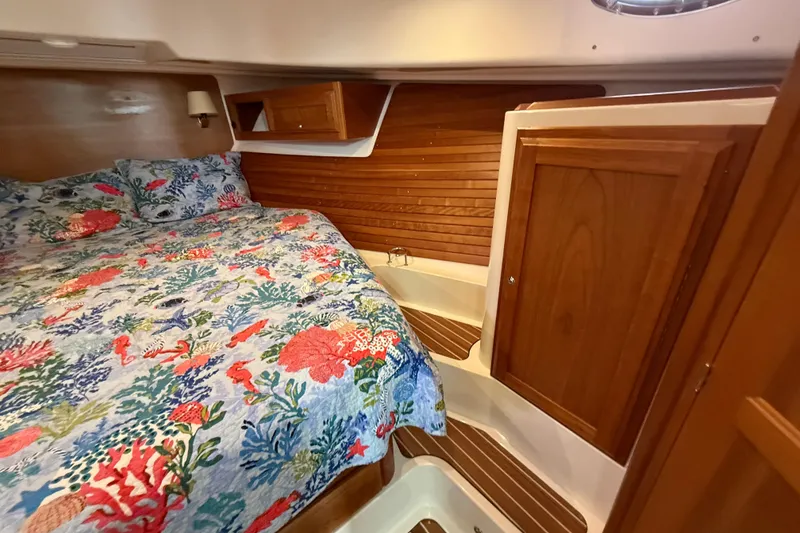 Slide: The Image of Cozy cabin interior of 2022 Back Cove 39O with floral bedding and wooden accents. - 59