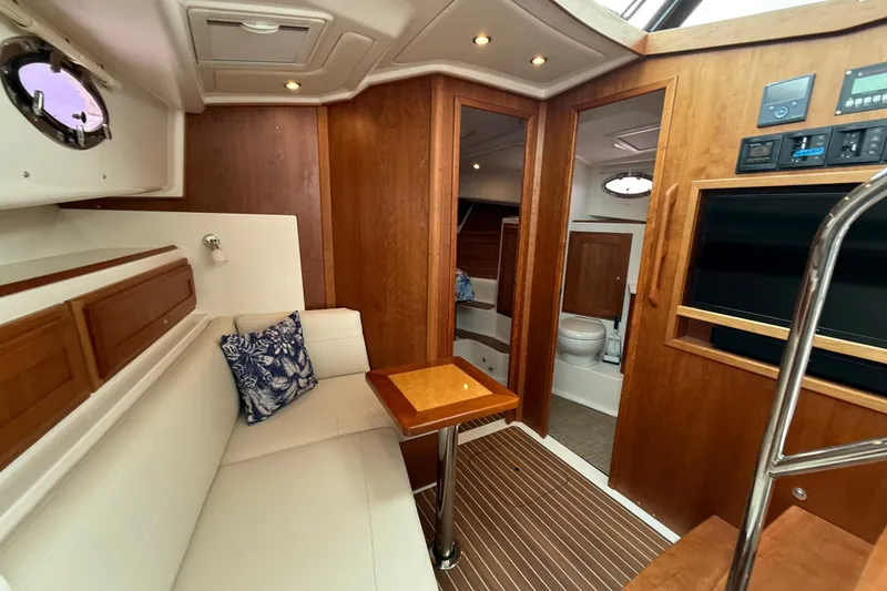 Slide: The Image of Luxurious interior of 2022 Back Cove 39O yacht with elegant wood finishes and cozy seating. - 52