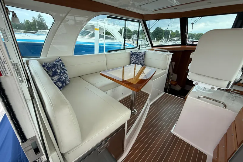Slide: The Image of Luxurious interior of 2022 Back Cove 39O yacht with elegant seating and wooden table. - 30