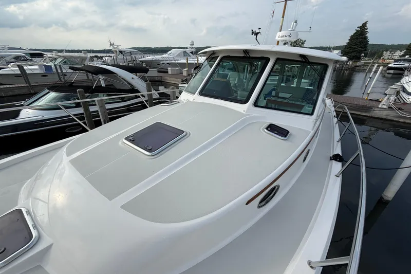 Slide: The Image of 2022 Back Cove 39O yacht docked at marina, showcasing sleek design and spacious deck. - 23