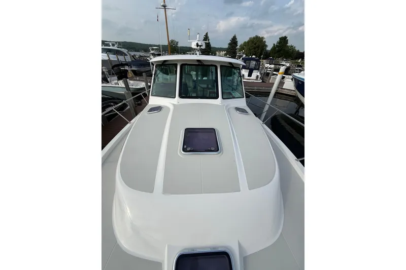 Slide: The Image of 2022 Back Cove 39O boat docked, showcasing sleek design and spacious deck. - 20