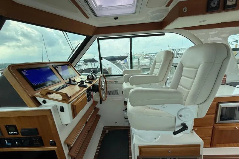 Slide: The Image of Luxurious helm of 2022 Back Cove 39O yacht with dual leather seats and advanced navigation. - 40