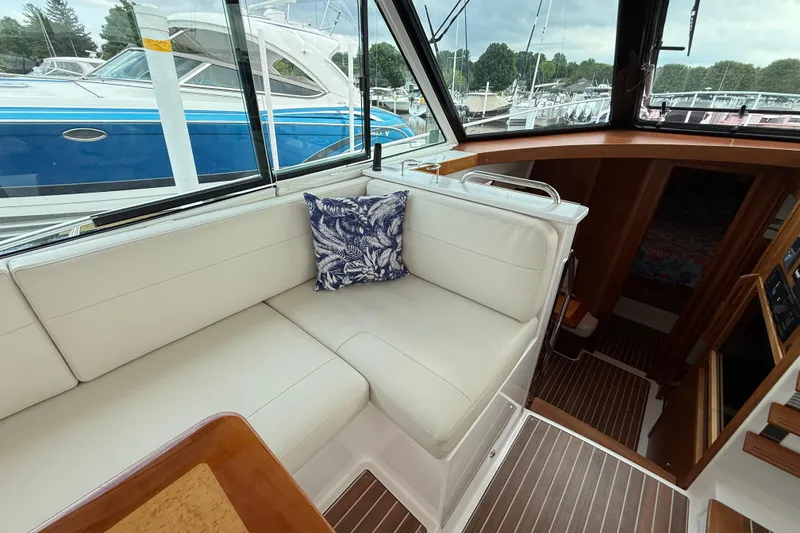 Slide: The Image of Interior of 2022 Back Cove 39O yacht with white seating and decorative pillow. - 33