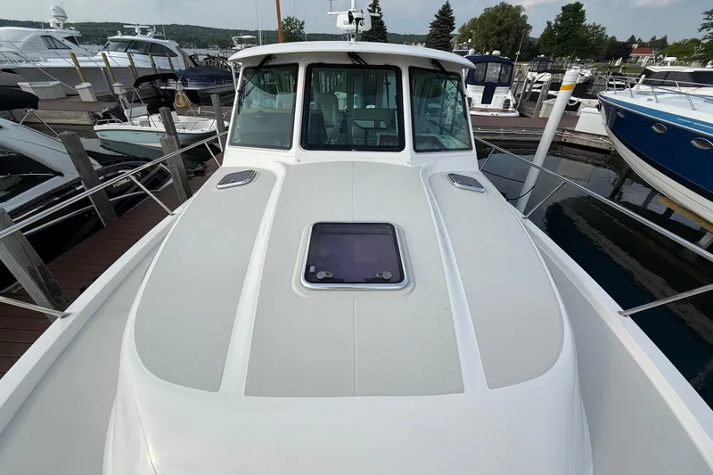 Slide: The Image of 2022 Back Cove 39O yacht docked at marina, showcasing sleek design and spacious deck. - 21