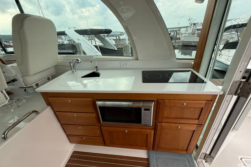 Slide: The Image of Interior of 2022 Back Cove 39O yacht featuring a modern kitchenette with sink and stove. - 36