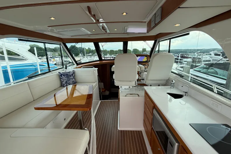 Slide: The Image of Interior of 2022 Back Cove 39O yacht with modern seating, table, and kitchenette. - 27