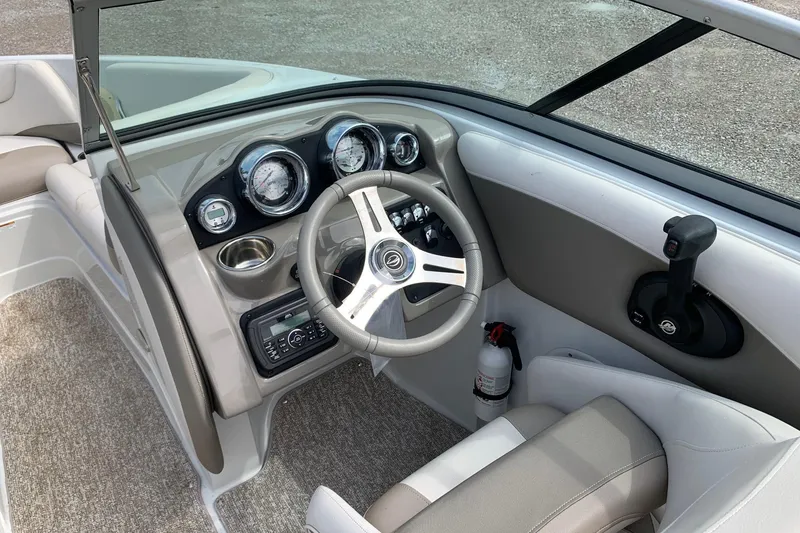Slide: The Image of 2018 Crownline 205 SS boat interior with steering wheel and dashboard controls. - 10