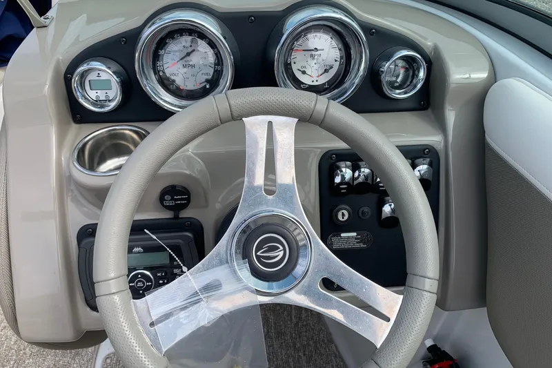 Slide: The Image of Steering wheel and dashboard of 2018 Crownline 205 SS boat with gauges and controls. - 11