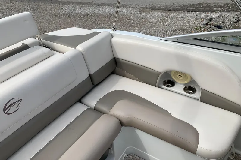 Slide: The Image of 2018 Crownline 205 SS boat interior with cushioned seating and cup holders. - 12
