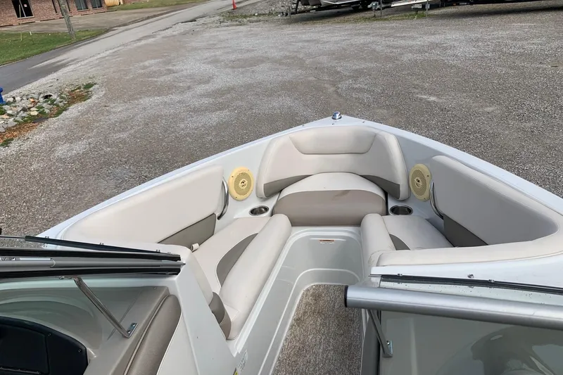 Slide: The Image of 2018 Crownline 205 SS boat interior with beige seating and speakers. - 15