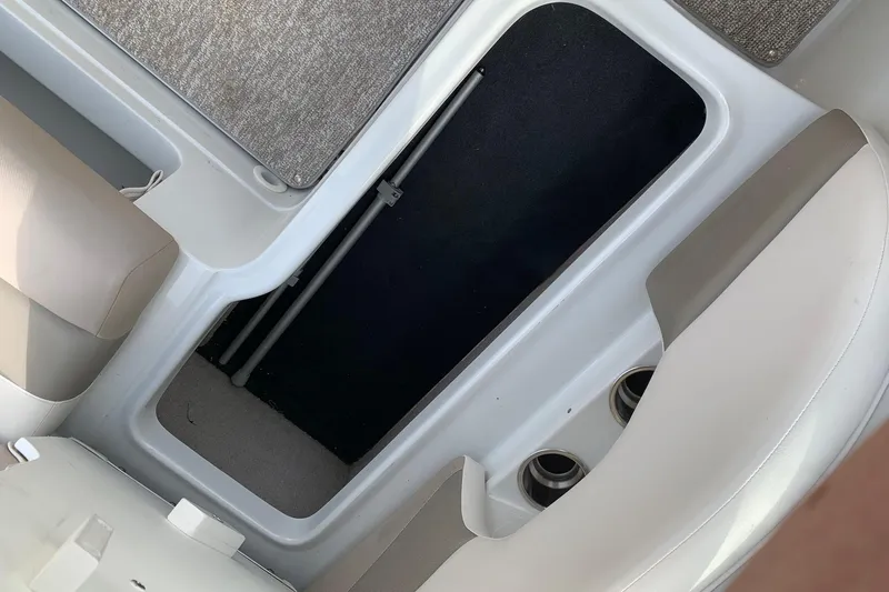 Slide: The Image of Interior view of a 2018 Crownline 205 SS boat, featuring seating and storage area. - 17