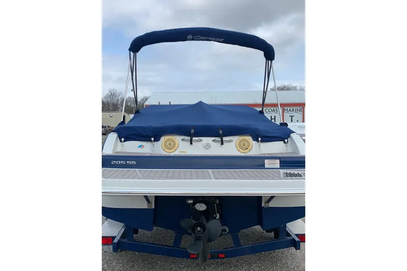 Slide: The Image of 2018 Crownline 205 SS boat with blue cover and canopy, rear view. - 2