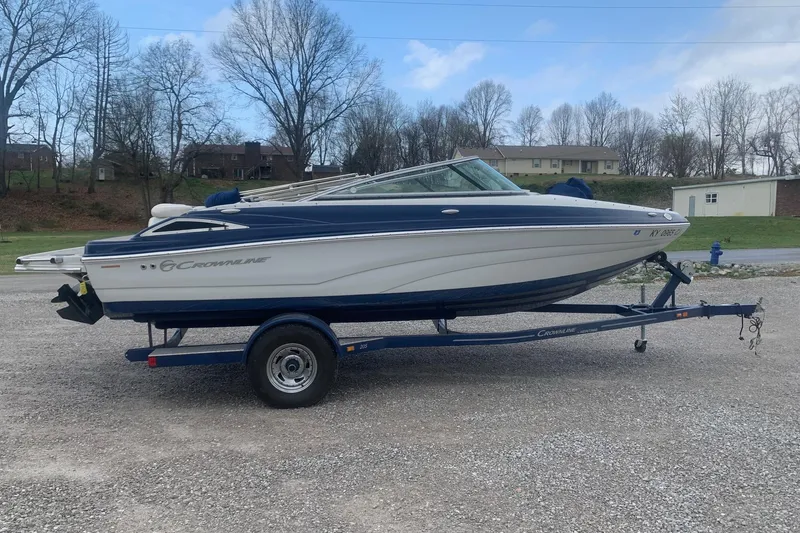 Slide: The Image of 2018 Crownline 205 SS boat on trailer, parked outdoors on gravel. - 3