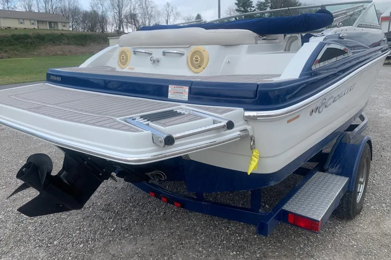 Slide: The Image of 2018 Crownline 205 SS boat on trailer, rear view with swim platform and ladder. - 5