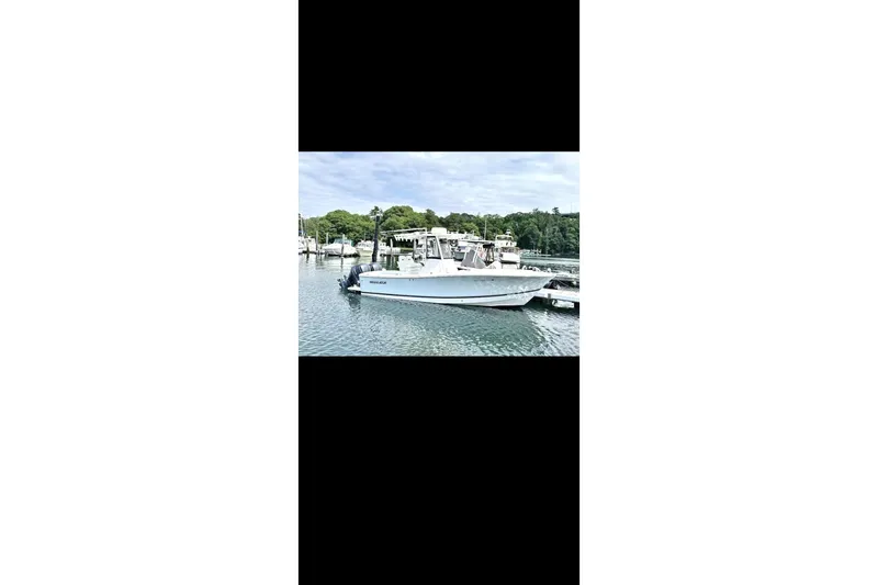 The Image of 2021 Regulator 25 boat docked in a serene marina setting. - 0