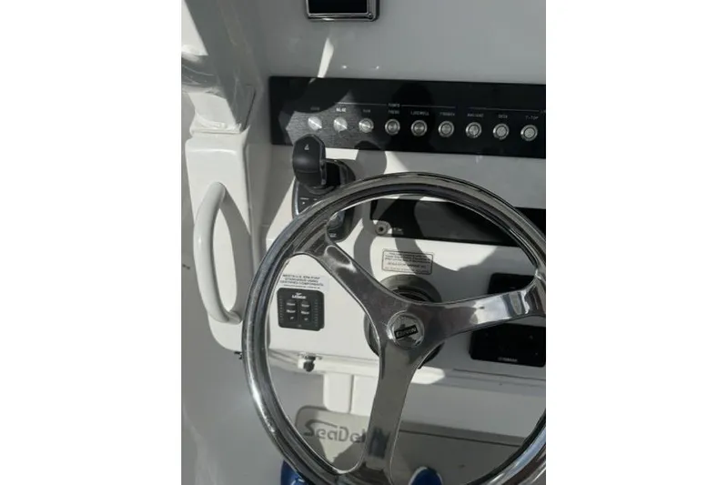 Slide: The Image of Steering wheel and controls of 2021 Regulator 25 boat cockpit. - 3