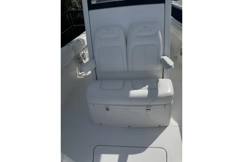 Slide: The Image of 2021 Regulator 25 boat seating with white cushioned bench and armrests. - 5