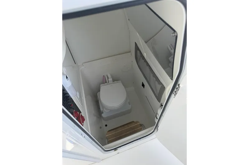 Slide: The Image of 2021 Regulator 25 boat interior with compact marine toilet. - 8