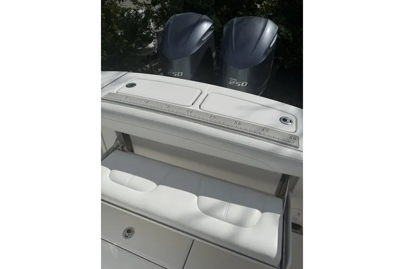 Slide: The Image of 2021 Regulator 25 boat with dual Yamaha 250 engines and measuring ruler on deck. - 9