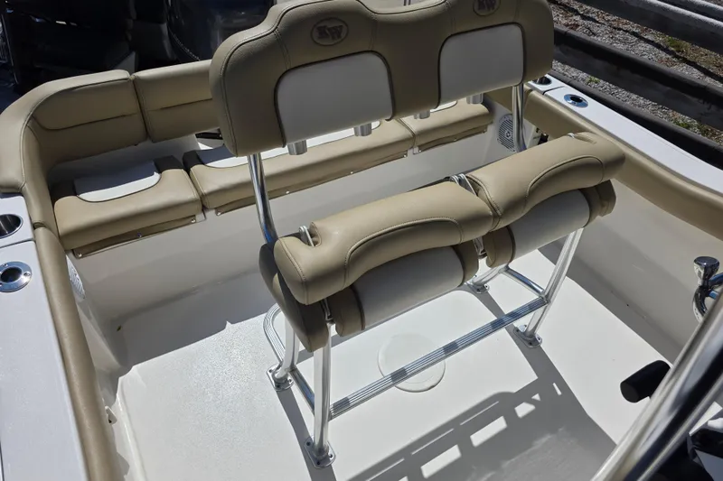 Slide: The Image of 2019 Key West 203 FS boat interior with beige seating and stainless steel fixtures. - 13