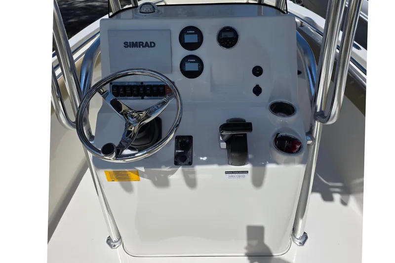 Slide: The Image of 2019 Key West 203 FS boat console with steering wheel and Simrad display. - 14