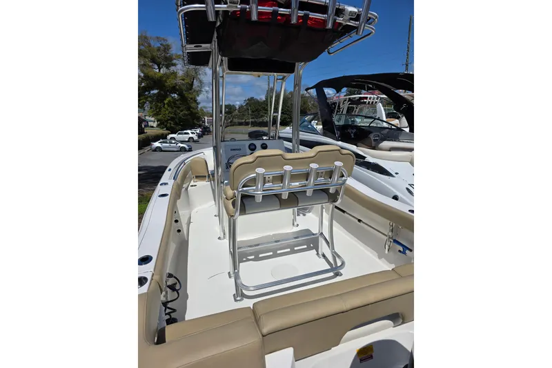 Slide: The Image of 2019 Key West 203 FS boat interior with beige seating and stainless steel fixtures. - 16
